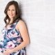 Smiling Pregnant Woman Holding Belly